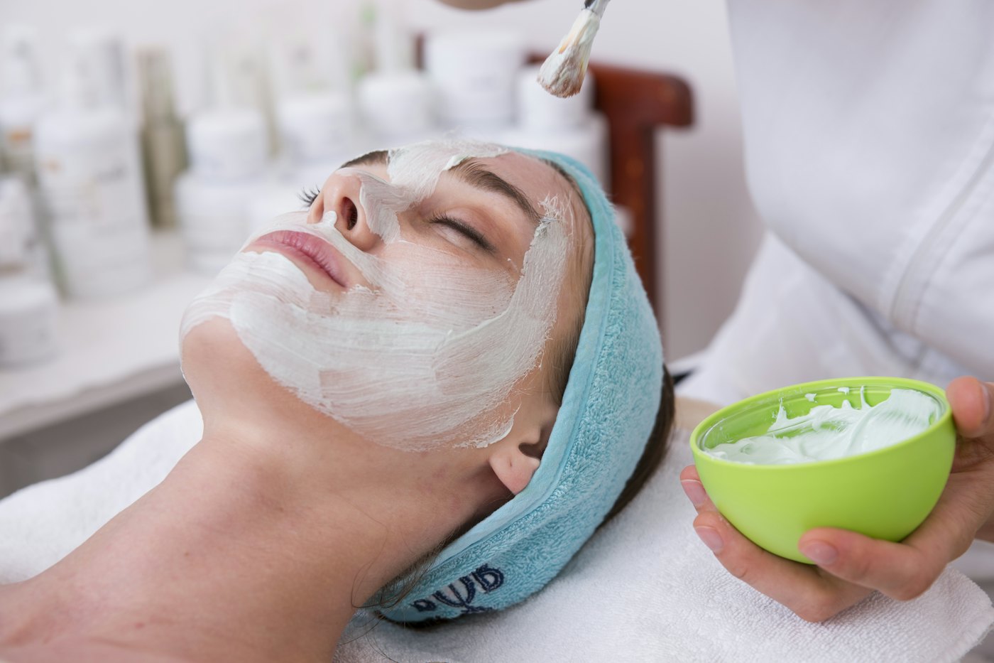 Mask being applied during a facial